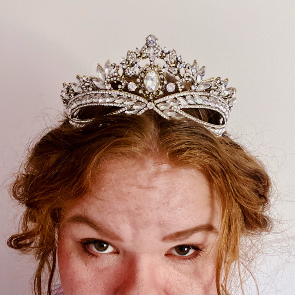 A phone of Victoria Koops, wearing a tiara. Photo frames top half of face, from nose and up.